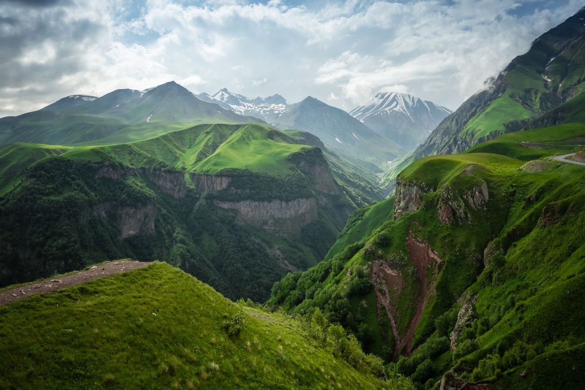 Caucasian Mountain ranges and valleys at Gudauri, Georgia. Summer day on the military-Georgian road. Rapid weather change in the mountains