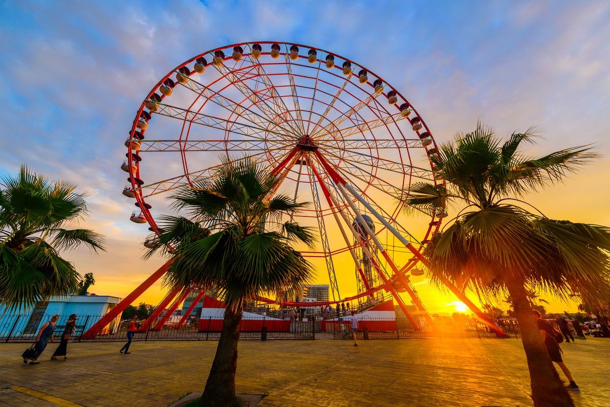 Ferris wheel on amazing sunset sky background