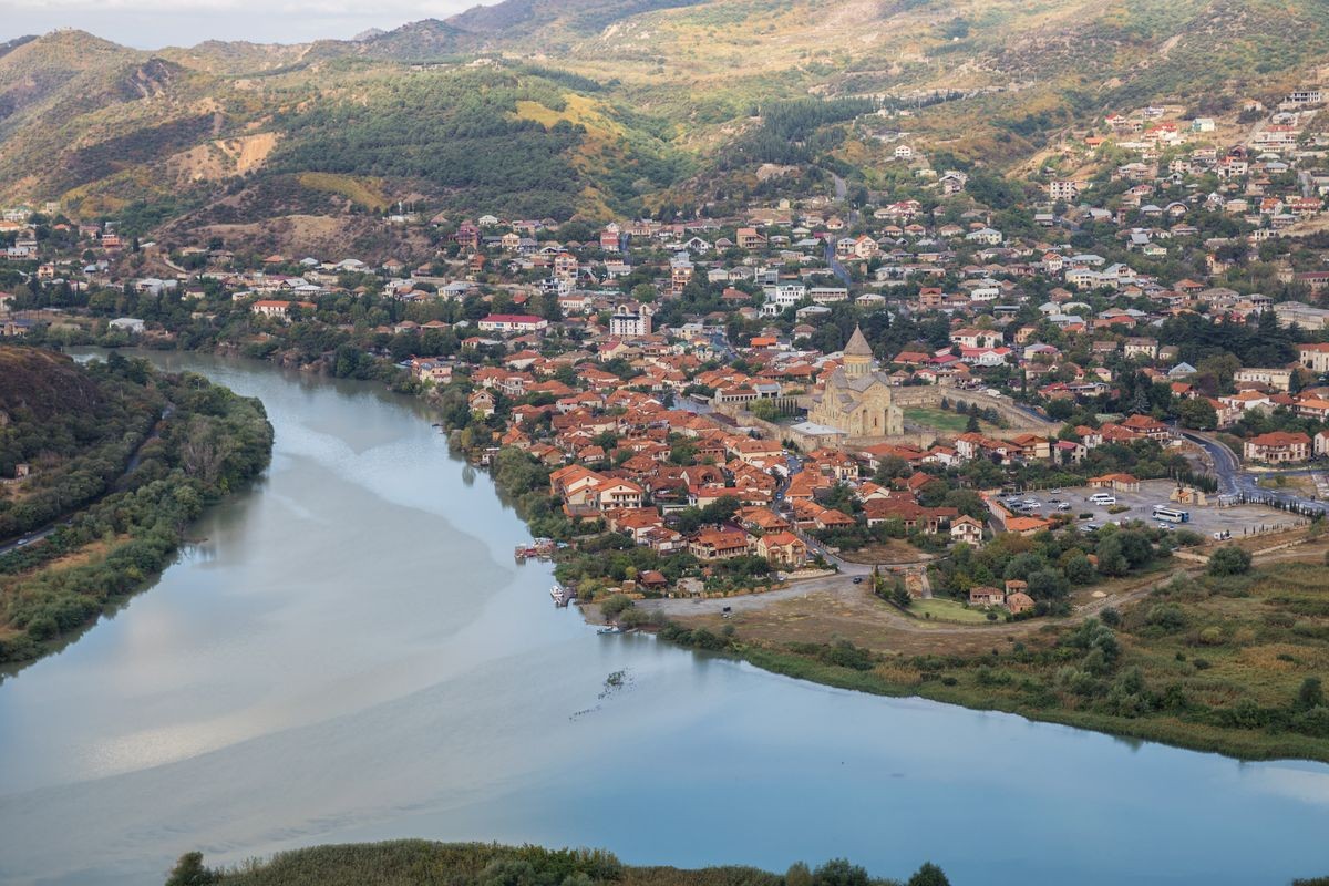 Top view to confluence of Aragvi and Kura rivers, town of Mtskheta and Svetitskhoveli Cathedral